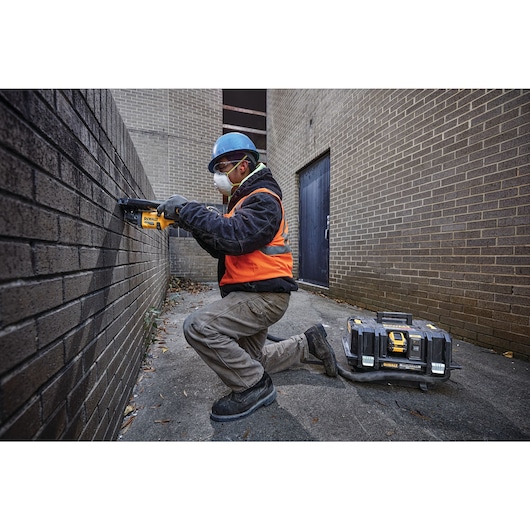 6 INCH CORDLESS GRINDER WITH KICKBACK BRAKE being used by a workman on a wall